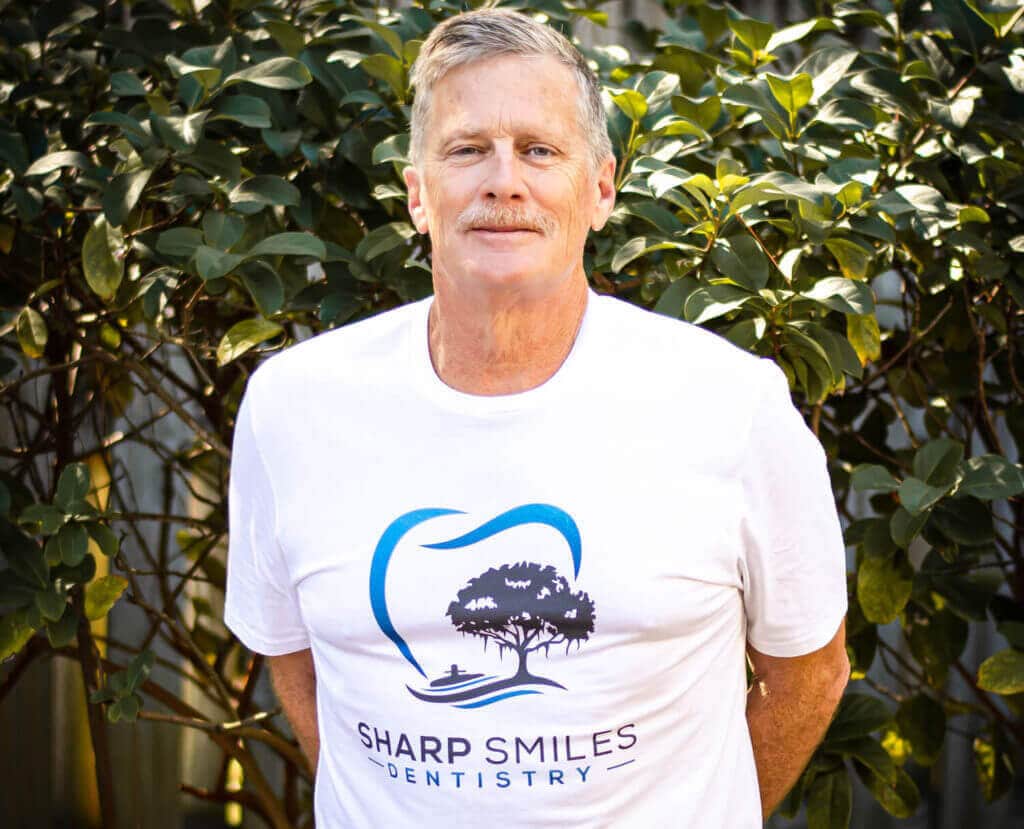 Dr. Hooton wearing a Sharp Smiles Dentistry t-shirt